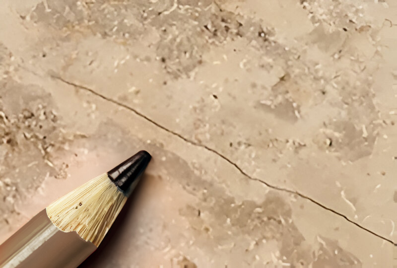 A close-up of marble tiling with a hairline crack